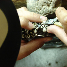 Jeweler adjusting prongs on setting