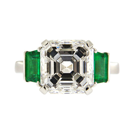 Asscher cut diamond engagement ring with emeralds on the sides